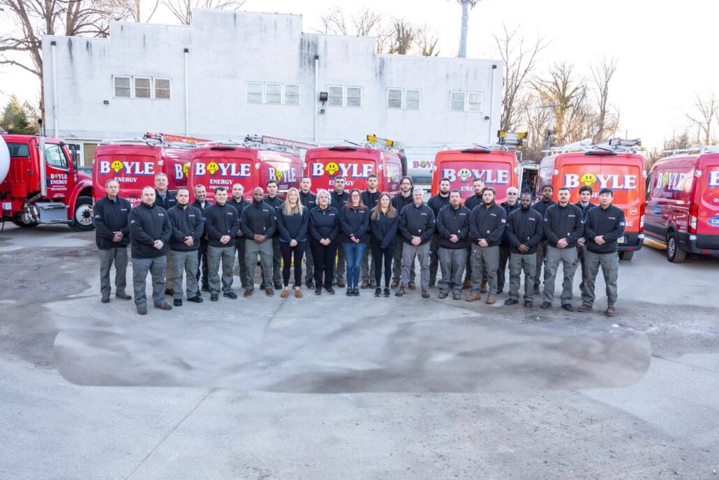 Boyle Team in front of branded vehicles