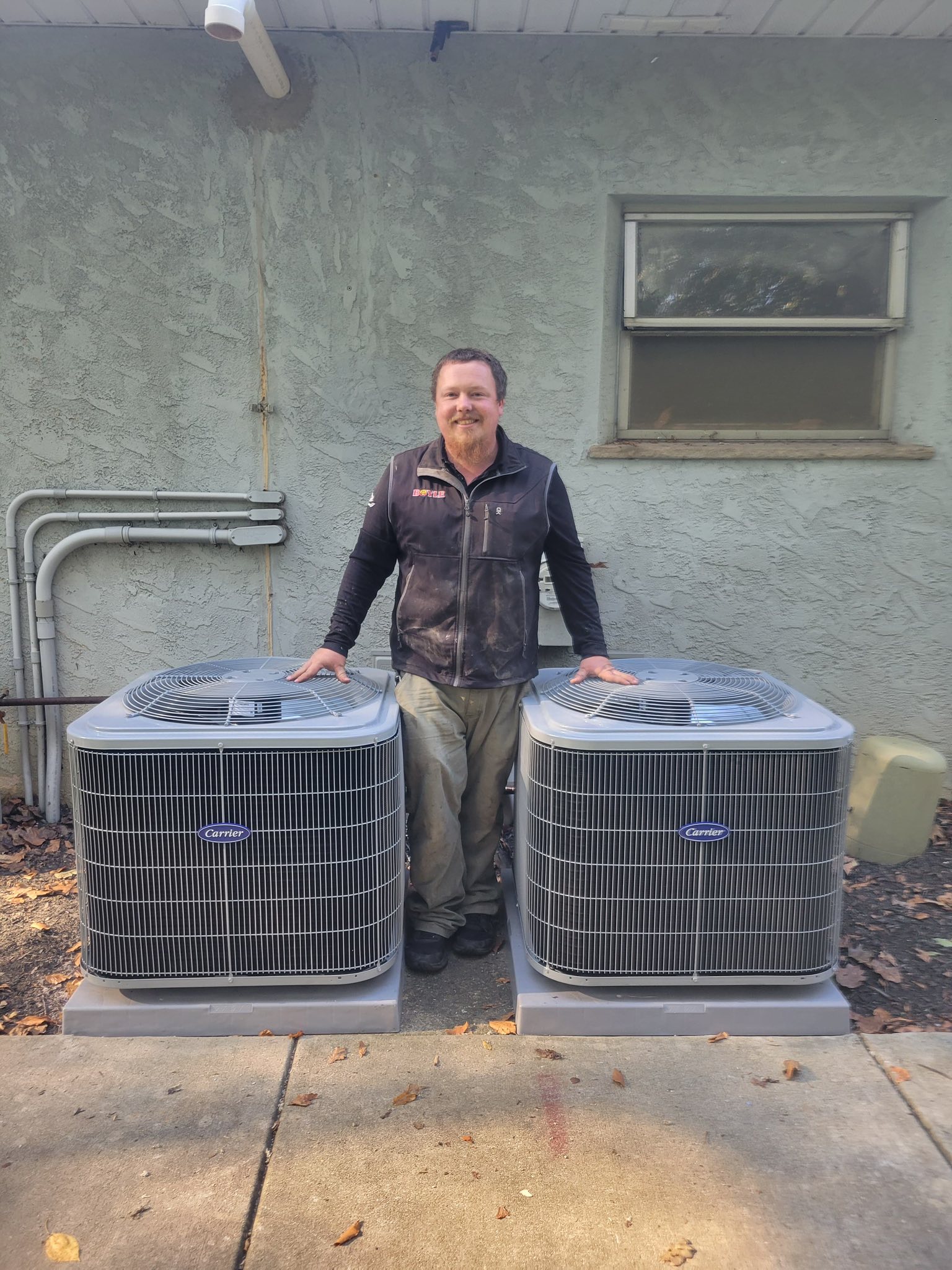 A man in uniform with an HVAC system