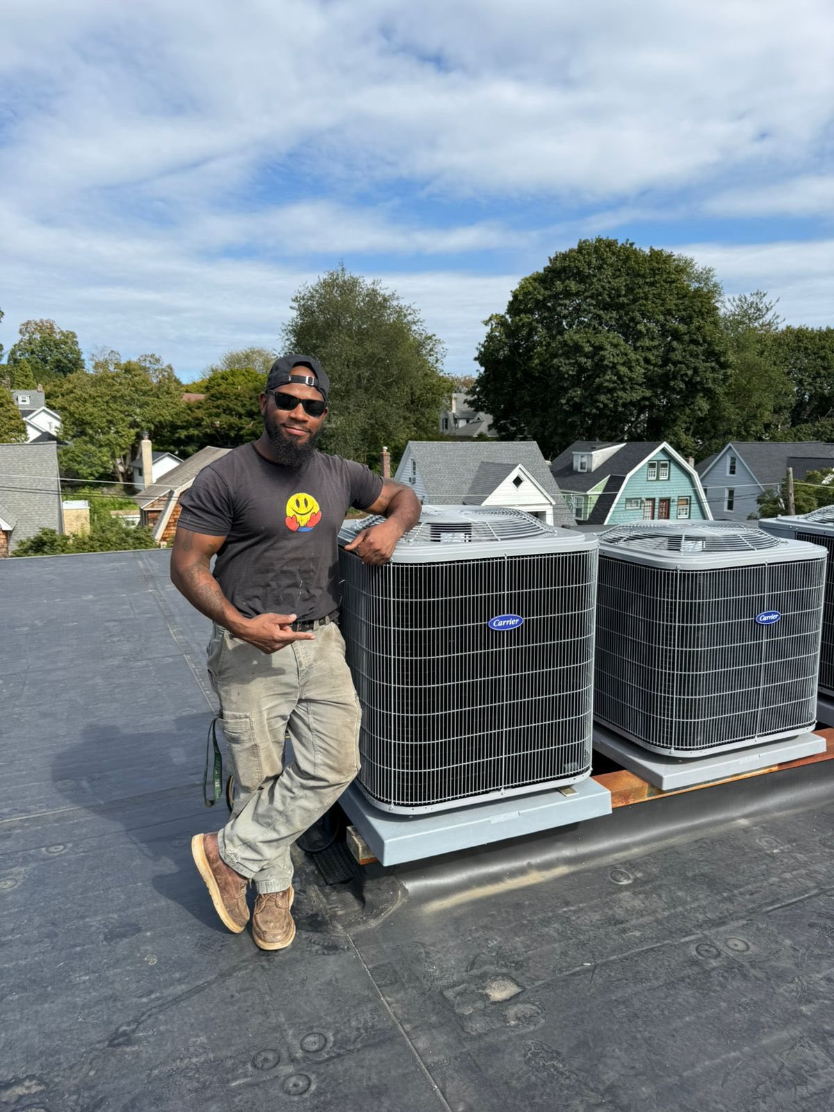 Boyle Energy Technician standing beside sir conditioning system