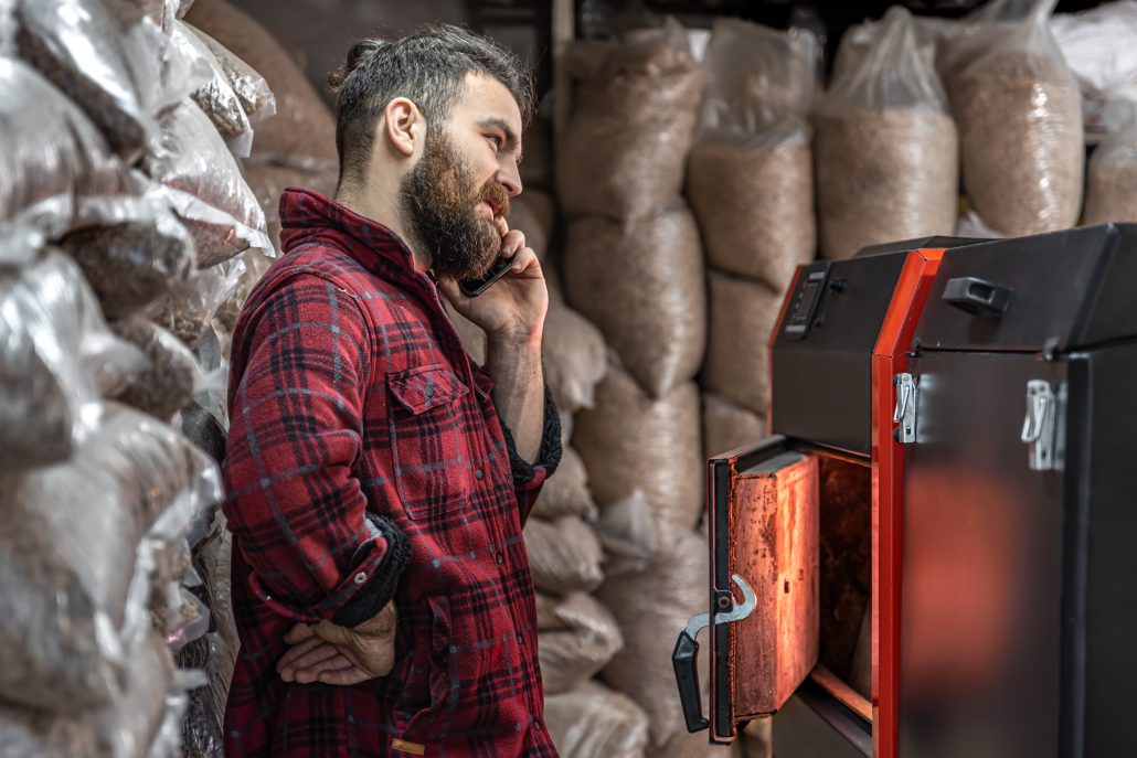 A young man with solid fuel boiler.