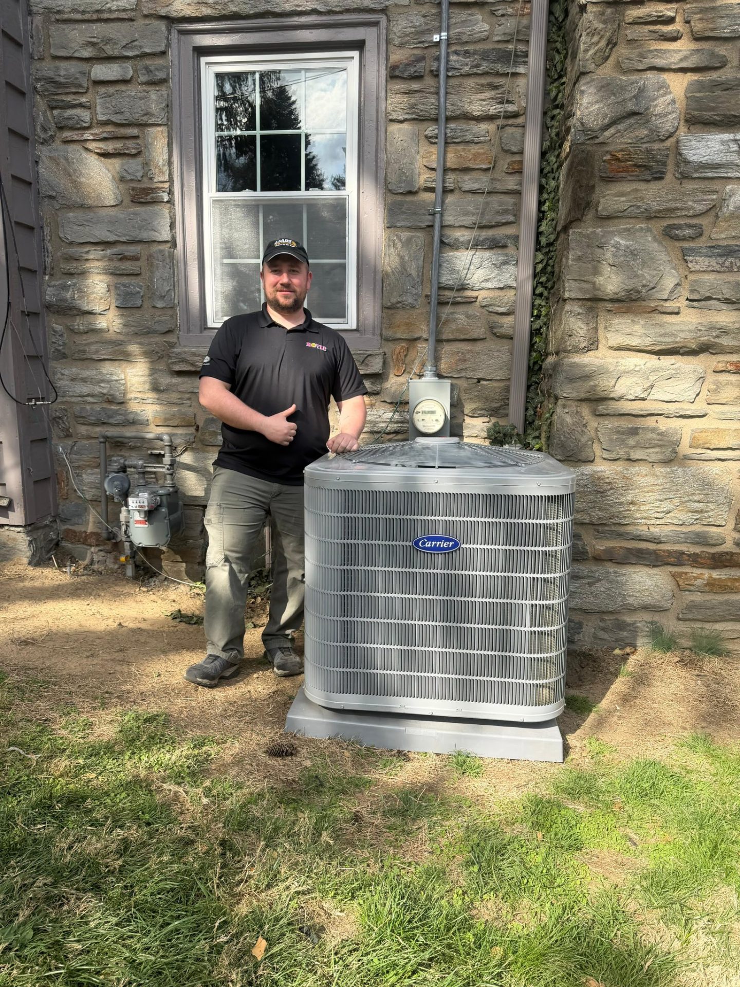Boyle technician standing beside an AC Unit