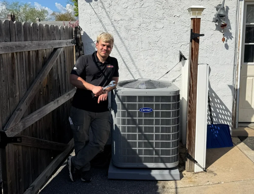 boyle technician standing beside HVAC unit