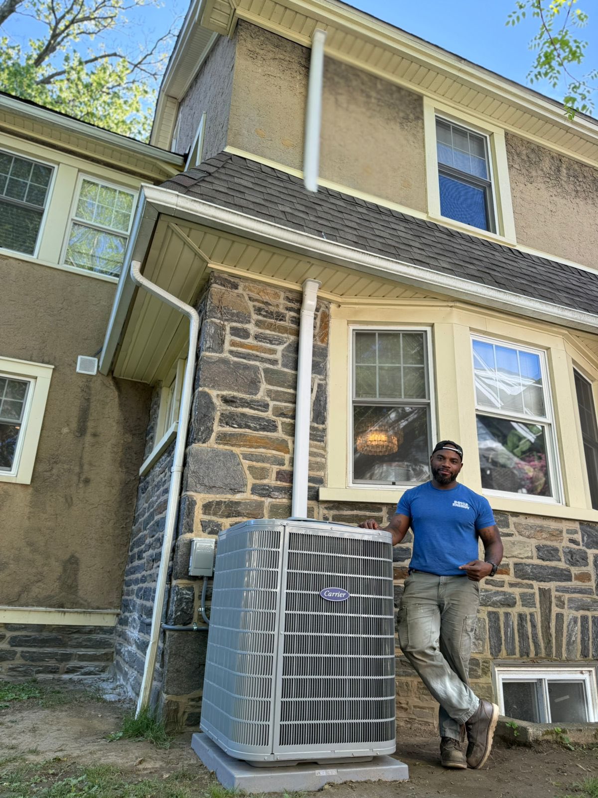 Boyle technician standing in front of a hone with an AC unit
