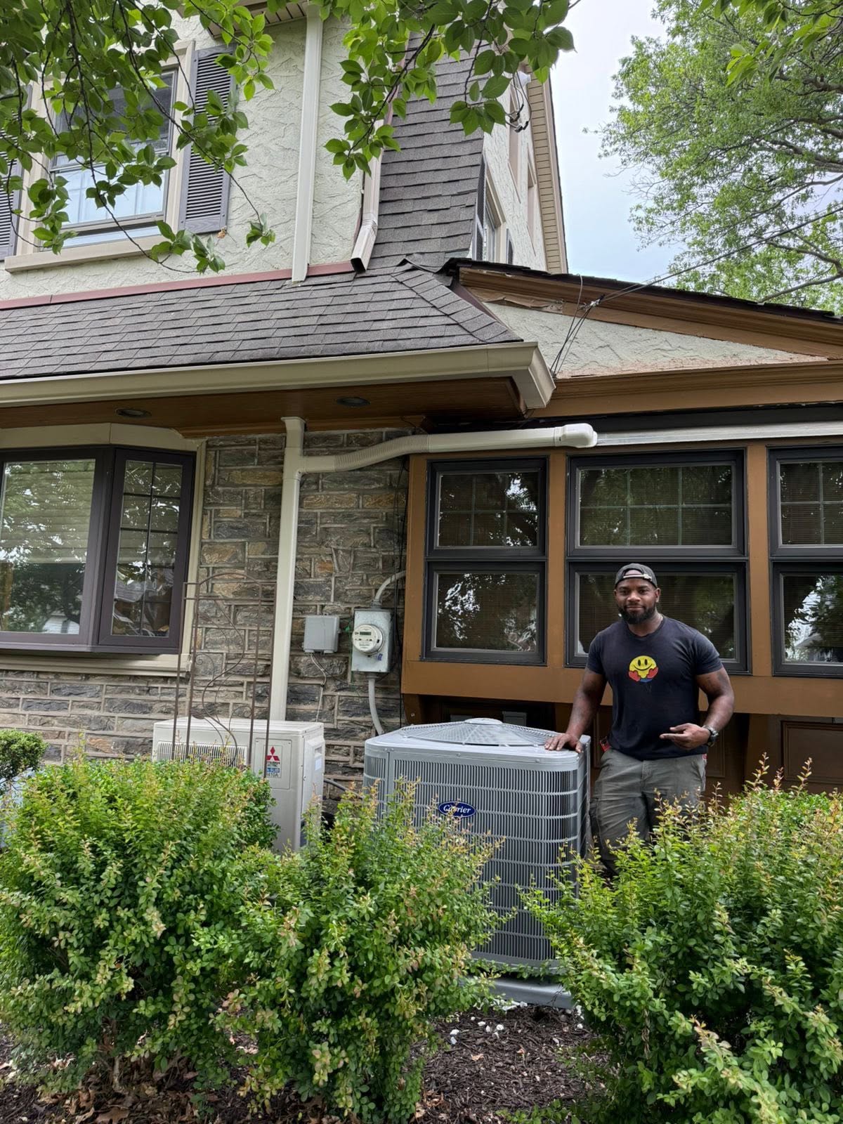 Boyle technician beside an AC unit